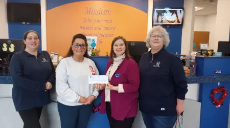 AAACU Team members pose with bags of trash they cleaned up in the community.